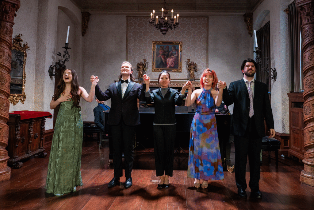 Five singers take a bow at the end of their performance